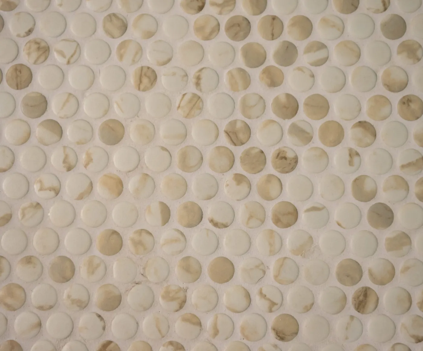 Marble penny round mosaic tile on a shower floor