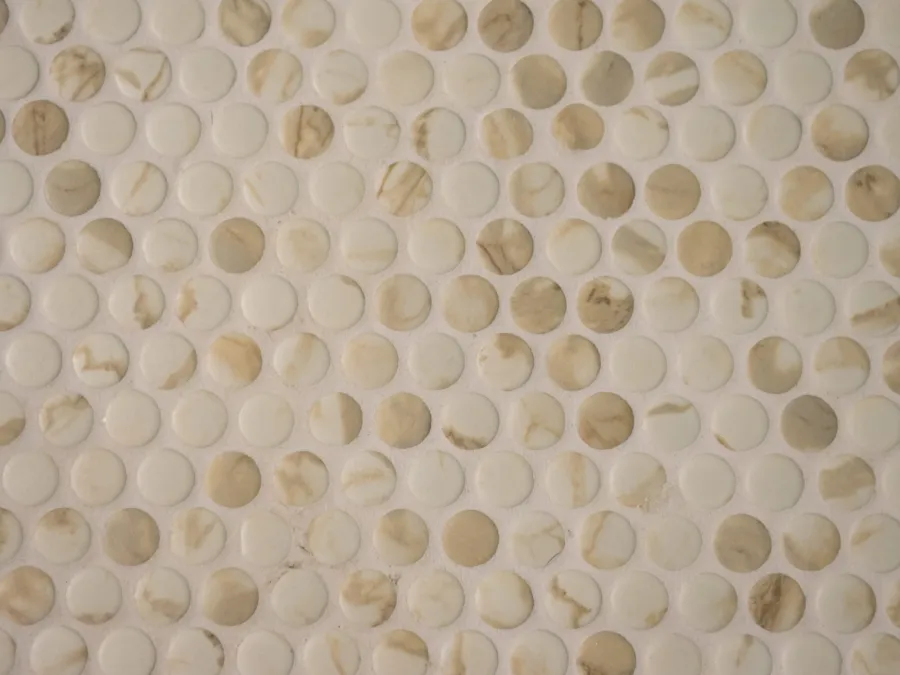 Marble penny round mosaic tile on a shower floor